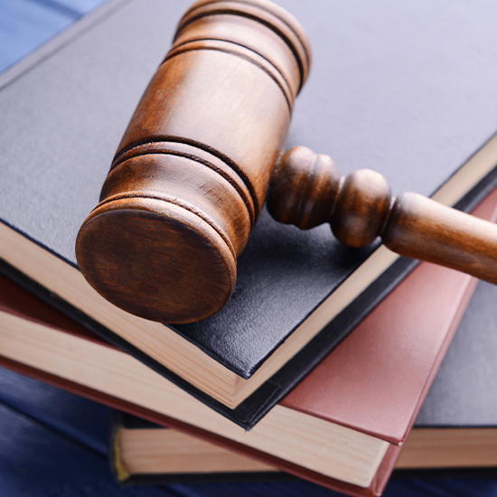 A gavel resting on a stack of books